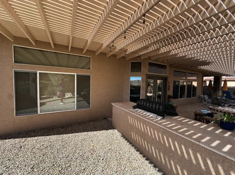 Patio windows cleaned under a pergola in Marble Falls