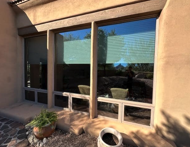 Large limestone-framed picture windows cleaned on a patio